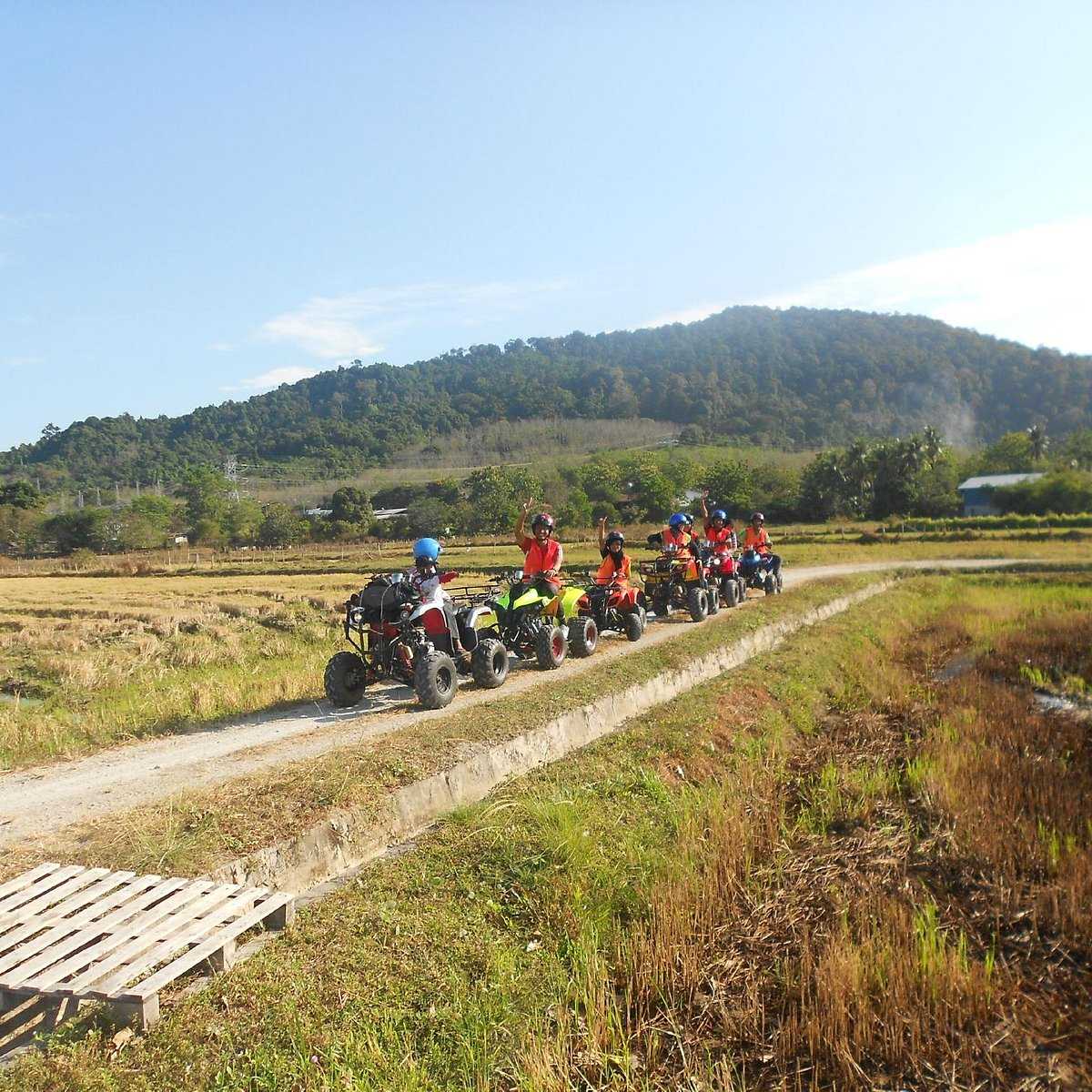 Tourists posing for photo in the countryside at ATV Adventure Ride Langkawi